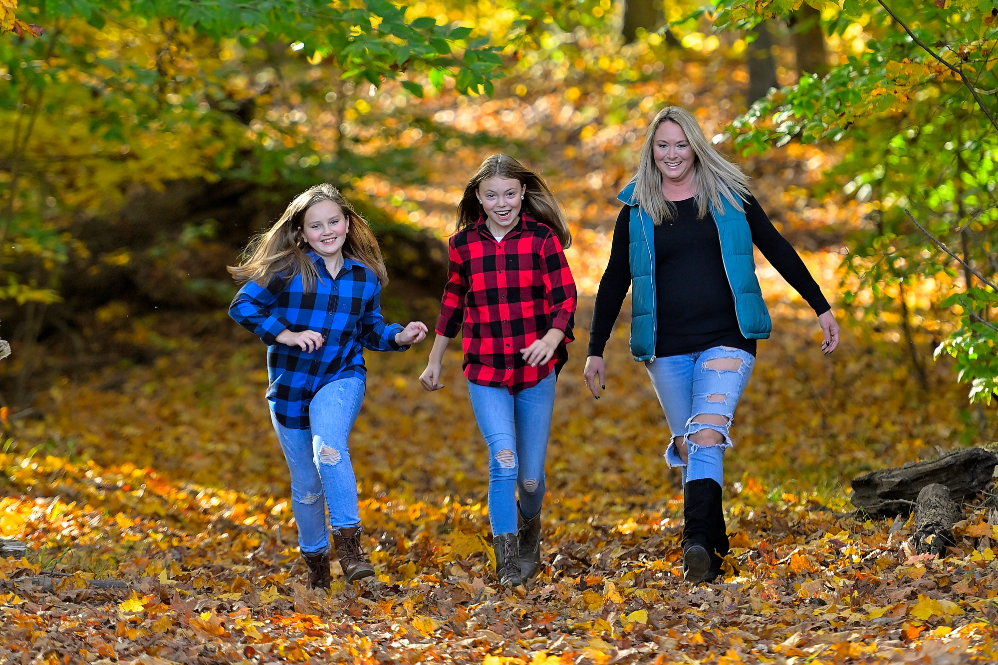 Mother Daughters hiking in fall leaves