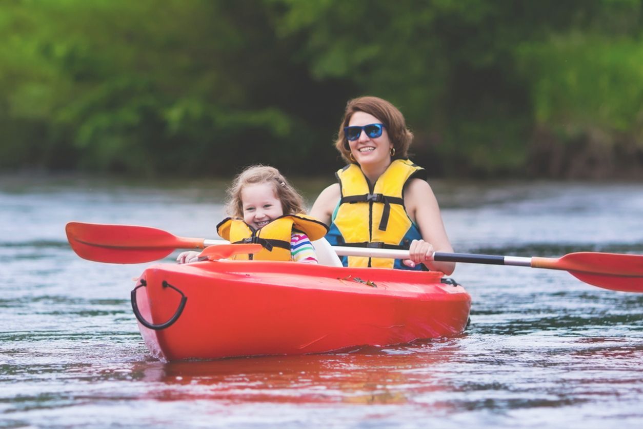 Mother and daughter canoeing on the river