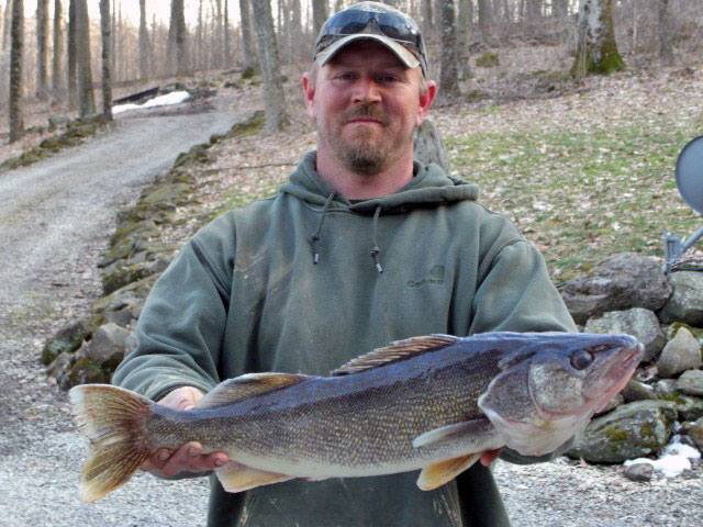Man holding a fish he caught.